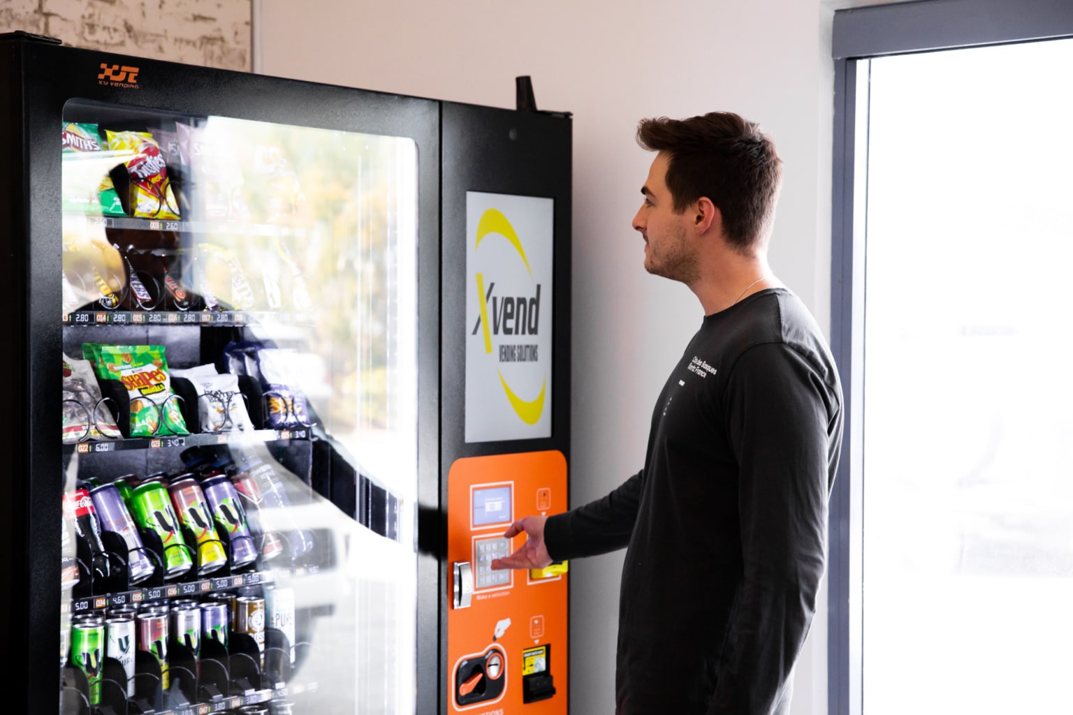 Employee Experiencing The Benefits Of Having A Food Vending Machine