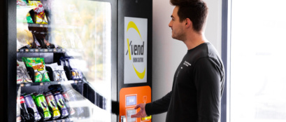 Employee Experiencing The Benefits Of Having A Food Vending Machine