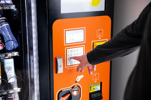Employee Using Vending Machine In Breakroom