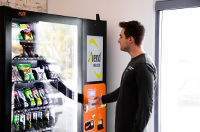 Employee Experiencing The Benefits Of Having A Vending Machine At Work